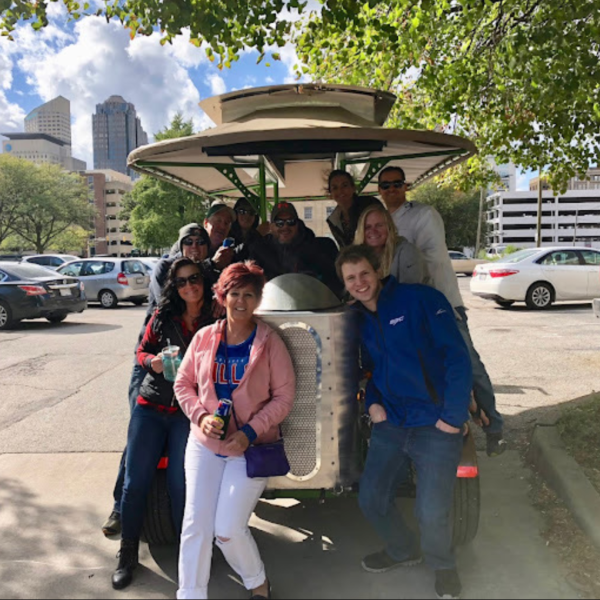 a group of people standing next to a car
